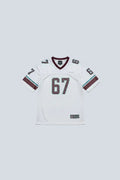 White sports jersey with number 67 on a mannequin in a room.