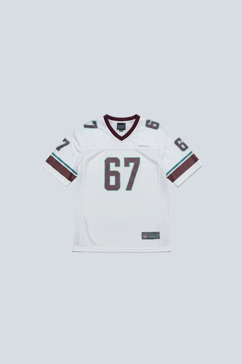 White sports jersey with number 67 on a mannequin in a room.